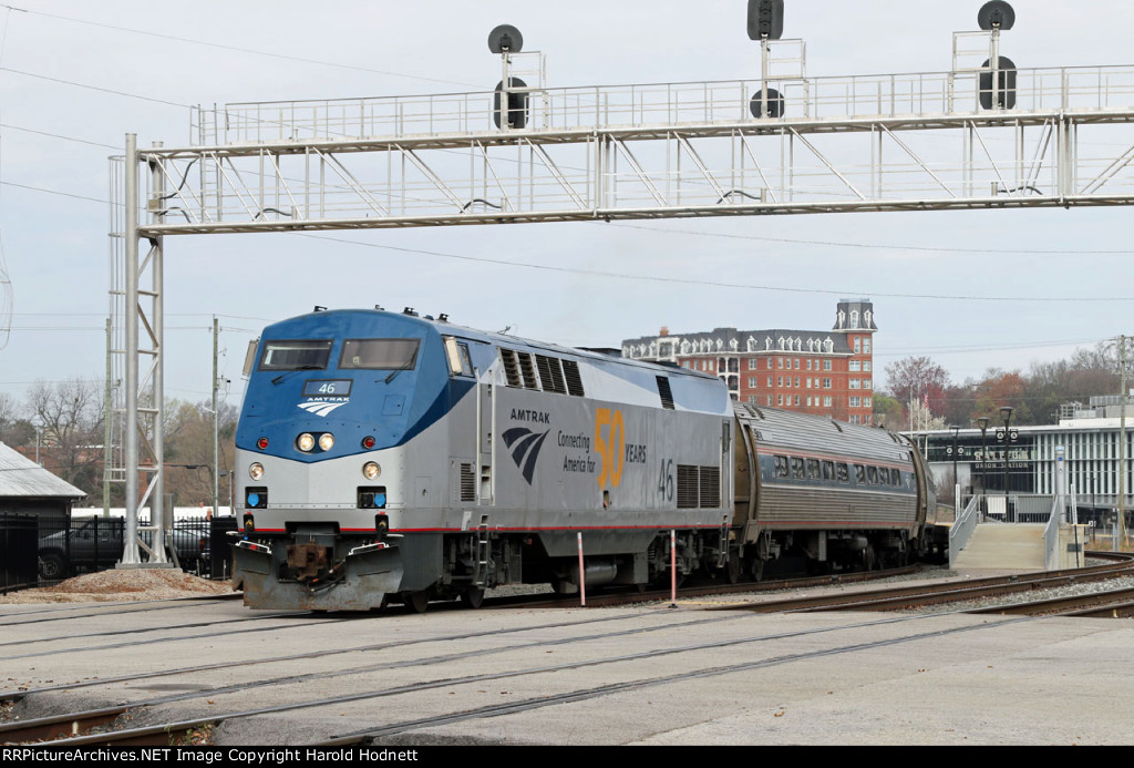 AMTK 46 leads train P080-16 away from the station